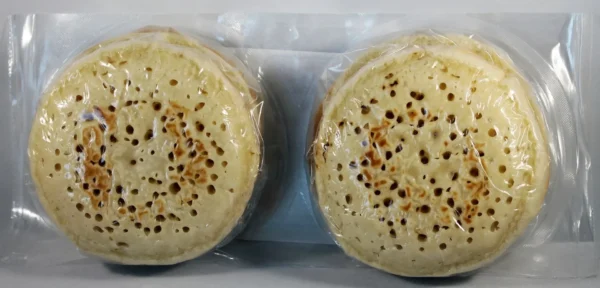 Two small round pastries in a plastic container.